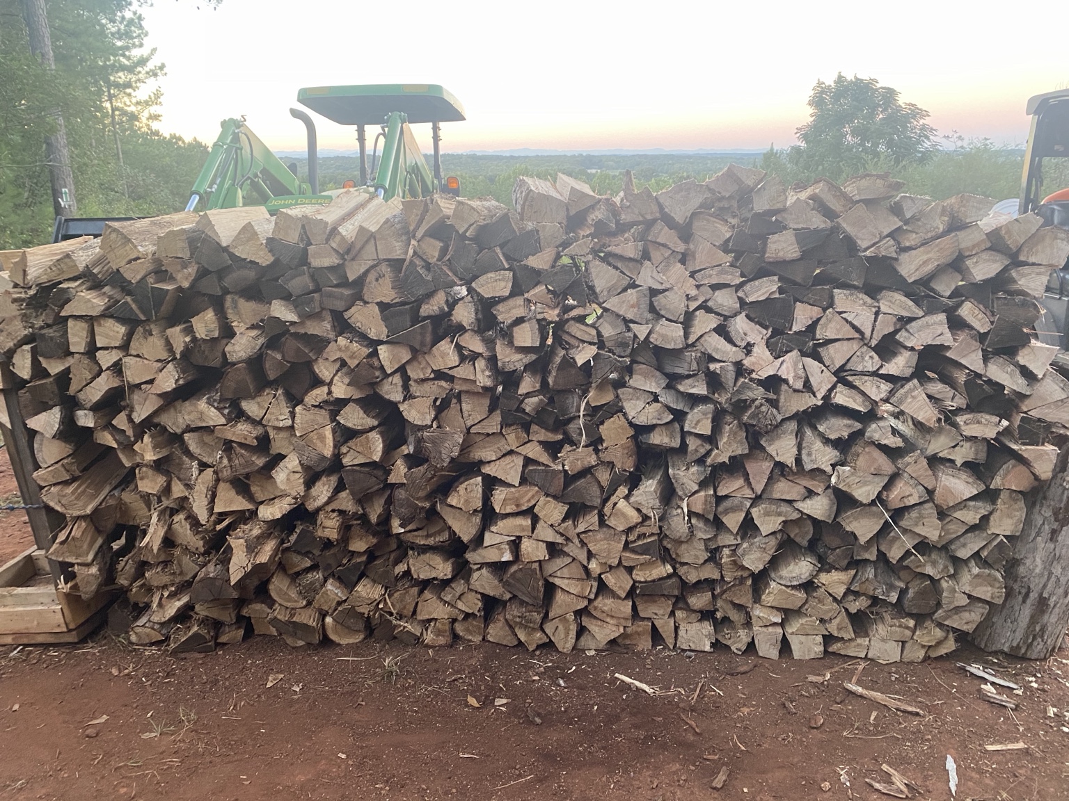 Large stack of split seasoned hardwood at Seasoned Stack Firewood Co.